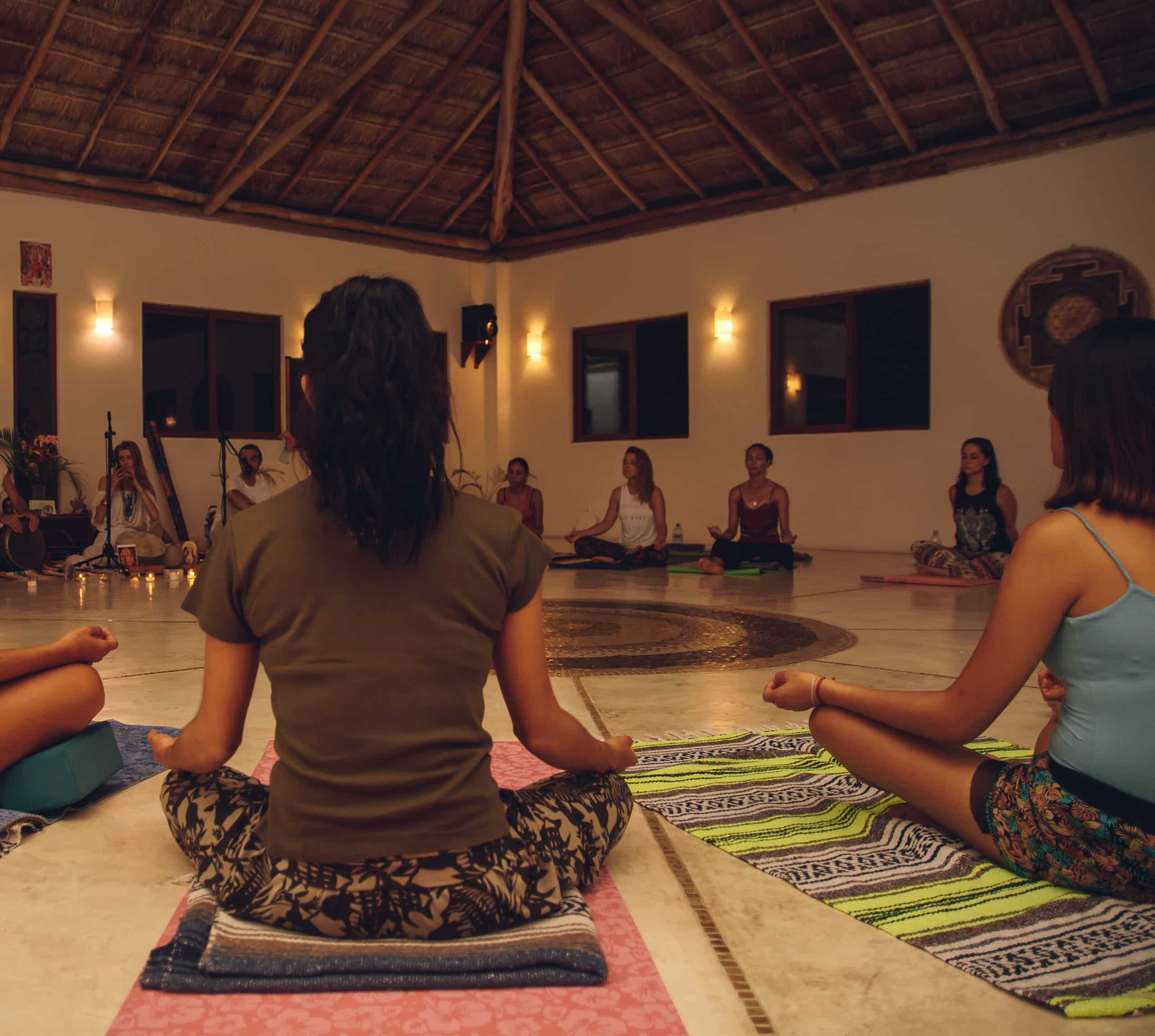 group of people in lotus position during healing ceremony