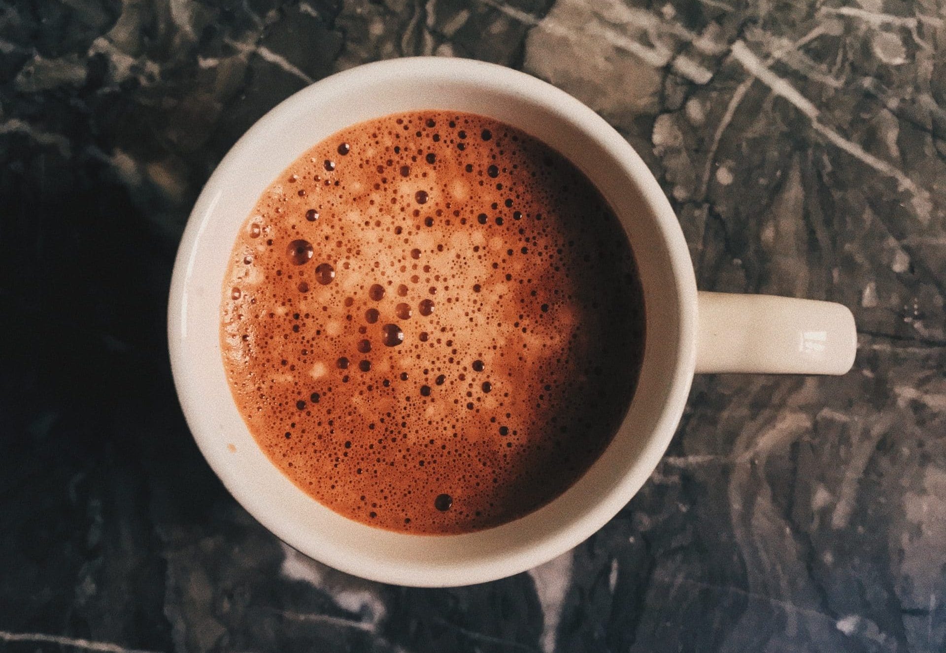 How to prepare ceremonial cacao, warm cacao in a white mug, ready to drink and enjoy.